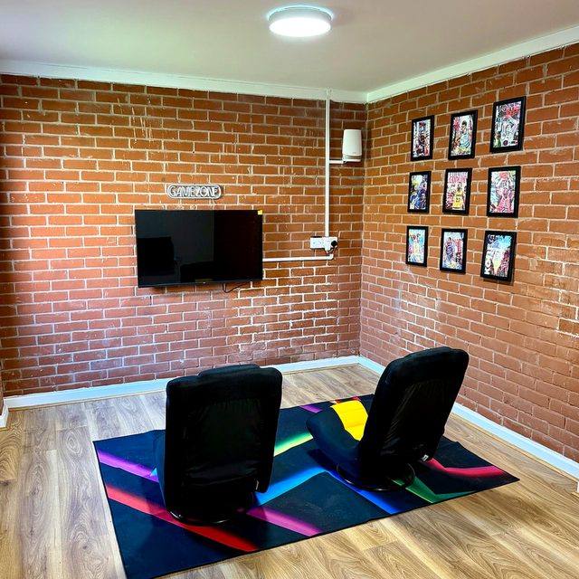 The games room at Hammond House, with a pool table and seating.