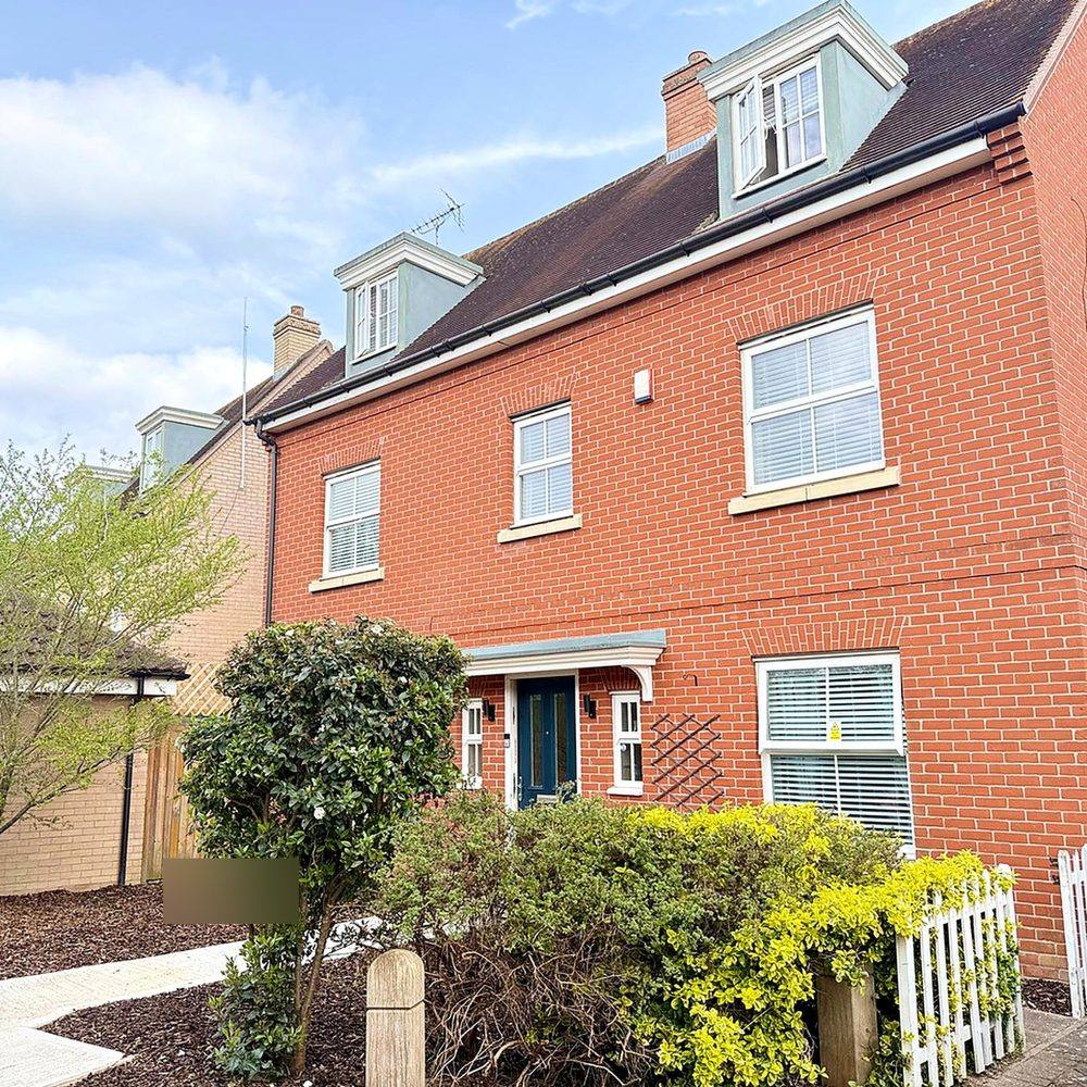 The front of Hammond House, showing off-street parking on the driveway and a level path leading to the front door.